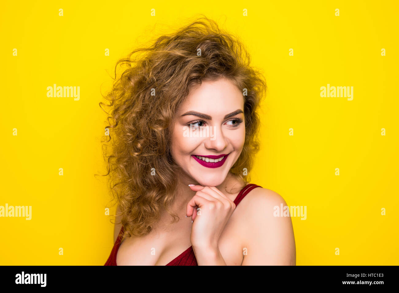 Young curly beauty woman posing on yellow background with different ...
