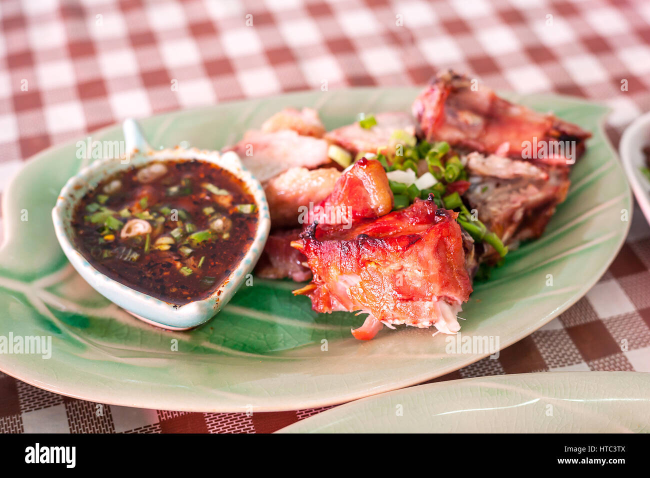 Grilled pork neck with dipping sauce in a northern Thai restaurant