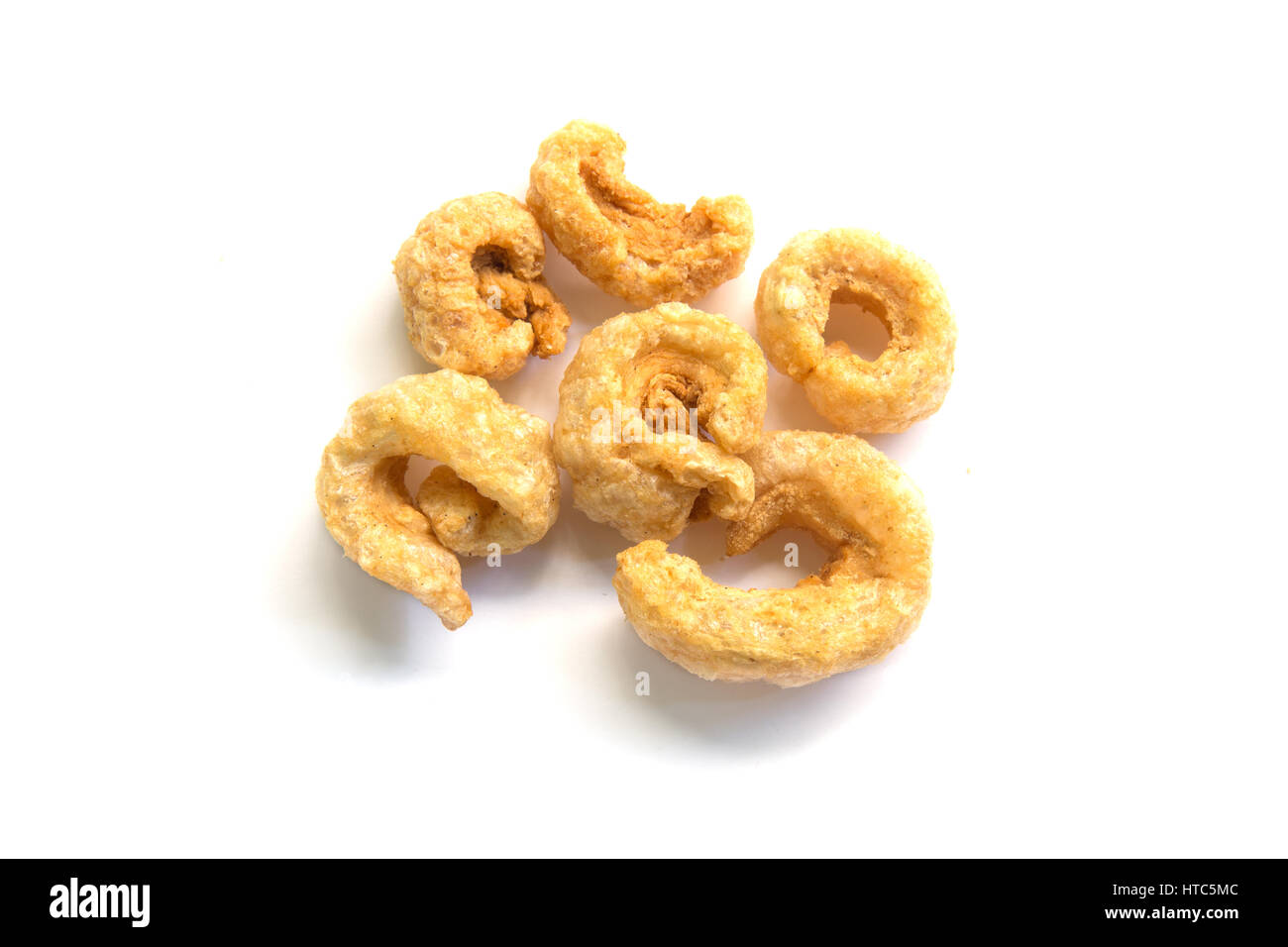 Pile of pork rind isolated on white background Stock Photo - Alamy
