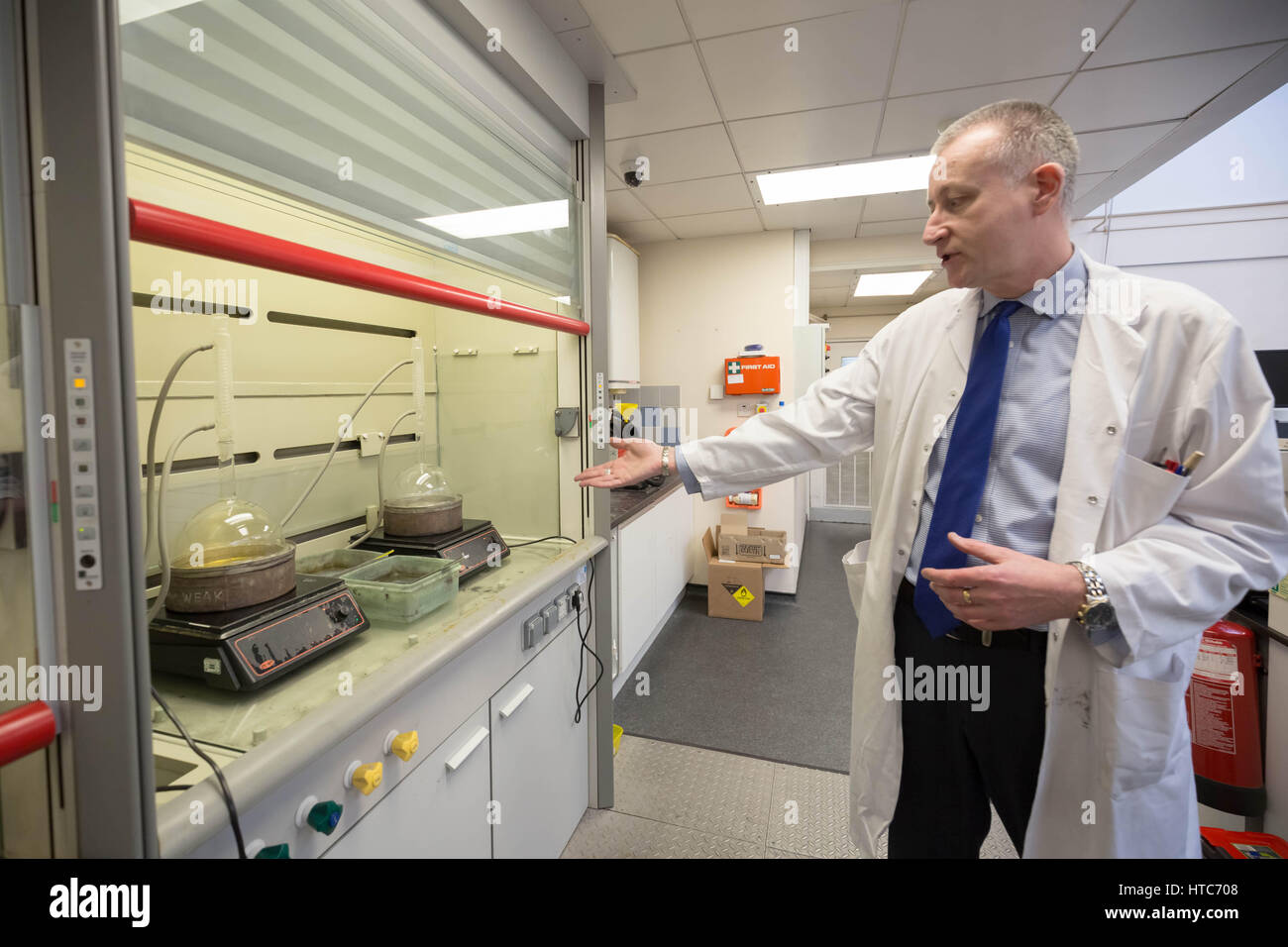 Chris Walne, the Laboratory Manager, at The Goldsmiths' Company Assay Office, performs a series of chemical tests on coins and metals. London, UK. Stock Photo