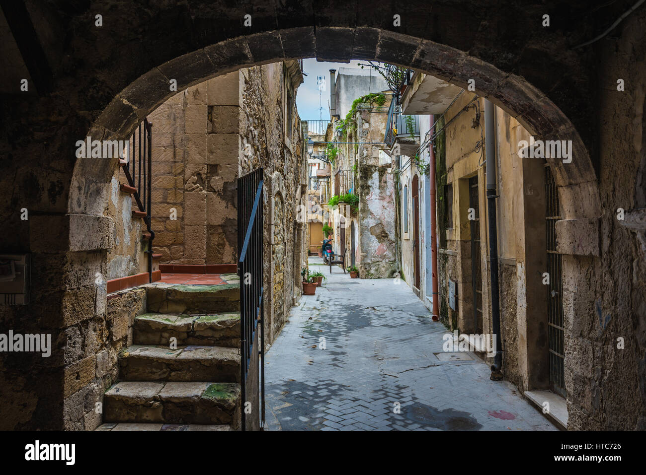 Narrow street on the Ortygia island, historical part of Syracuse city, southeast corner of the island of Sicily, Italy Stock Photo