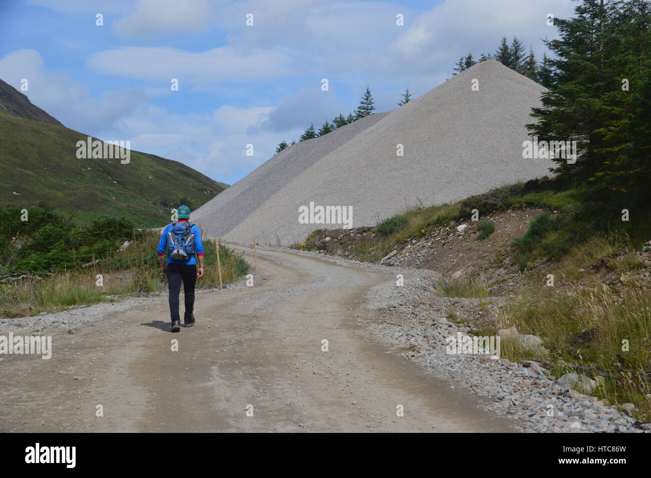 A Lone Male Hillwalker in Gleann Cia-aig Walking Through Constuction Site to the Scottish Mountain Corbett Meall na h-Eilde in the Scottish Highlands. Stock Photo