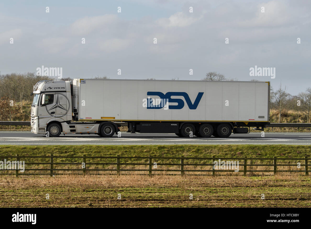 Distribution & transportation - an articulated lorry, heavy goods vehicle (HGV) with DSV slogan, travelling on the A1 motorway - England, GB, UK. Stock Photo