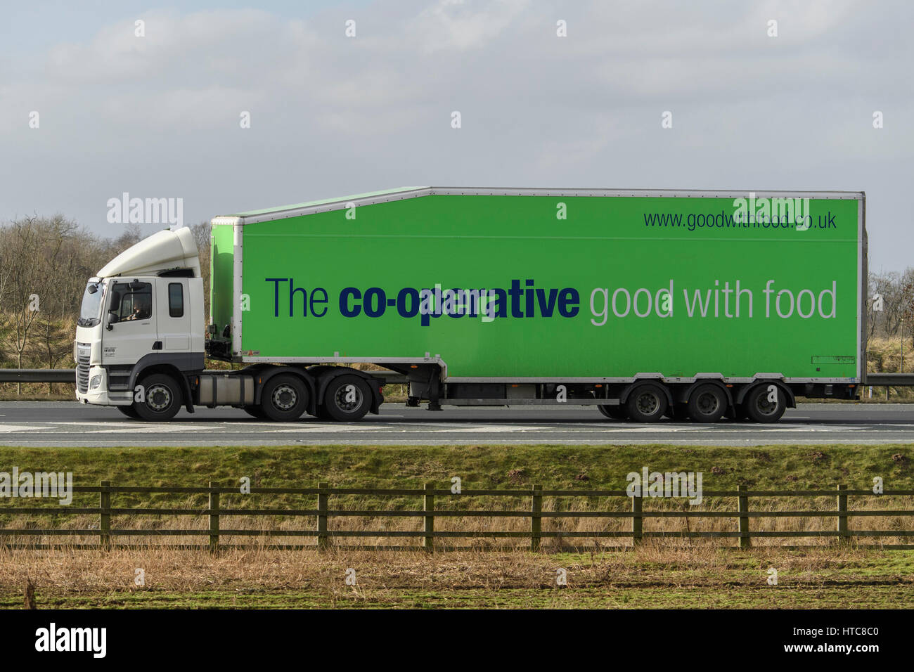 Distribution & transportation - an articulated lorry, heavy goods vehicle (HGV) with Co-op slogan, travelling on the A1 motorway - England, GB, UK. Stock Photo