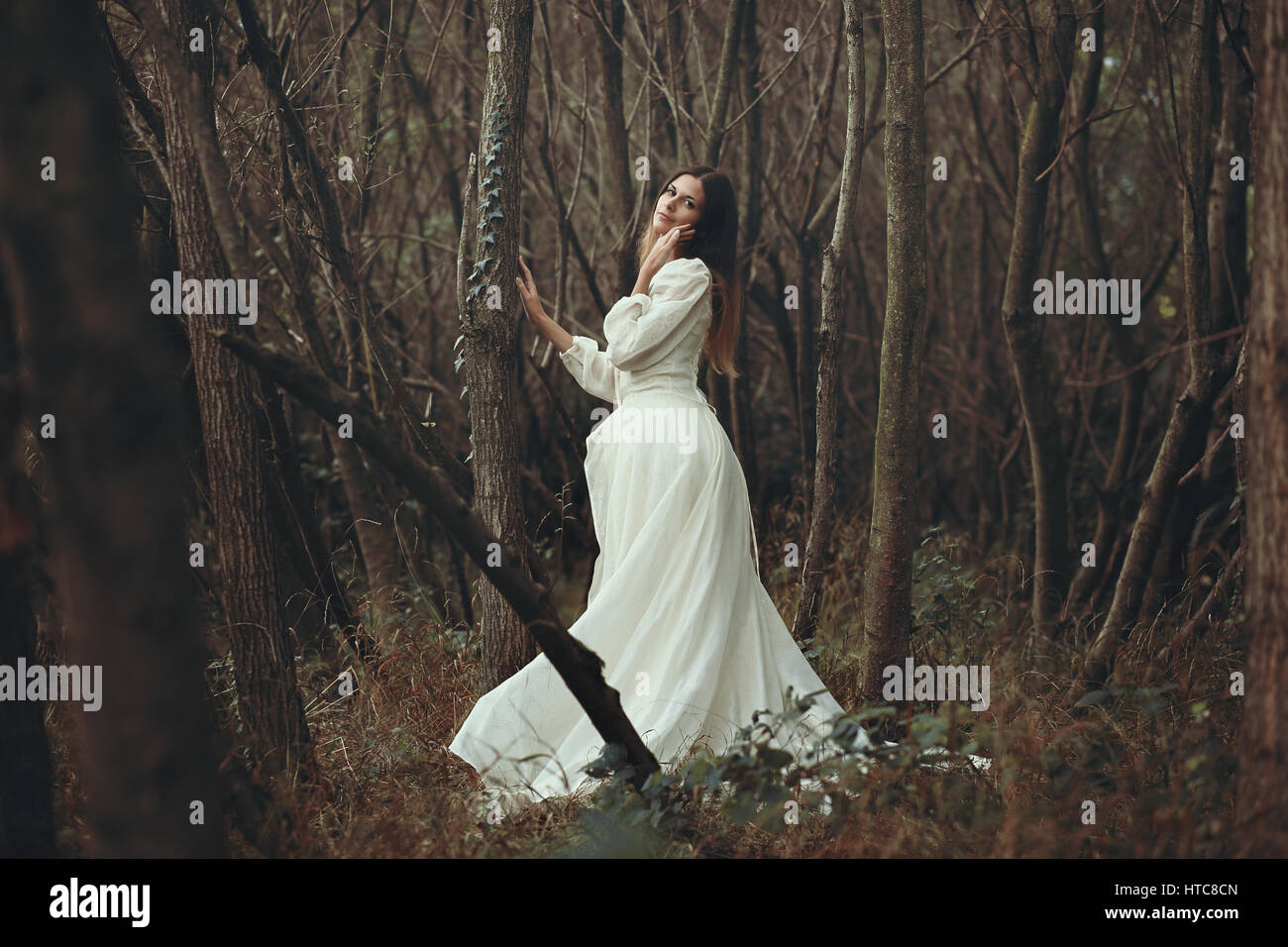 Romantic beautiful woman posing in autumn woods . Innocence and purity Stock Photo