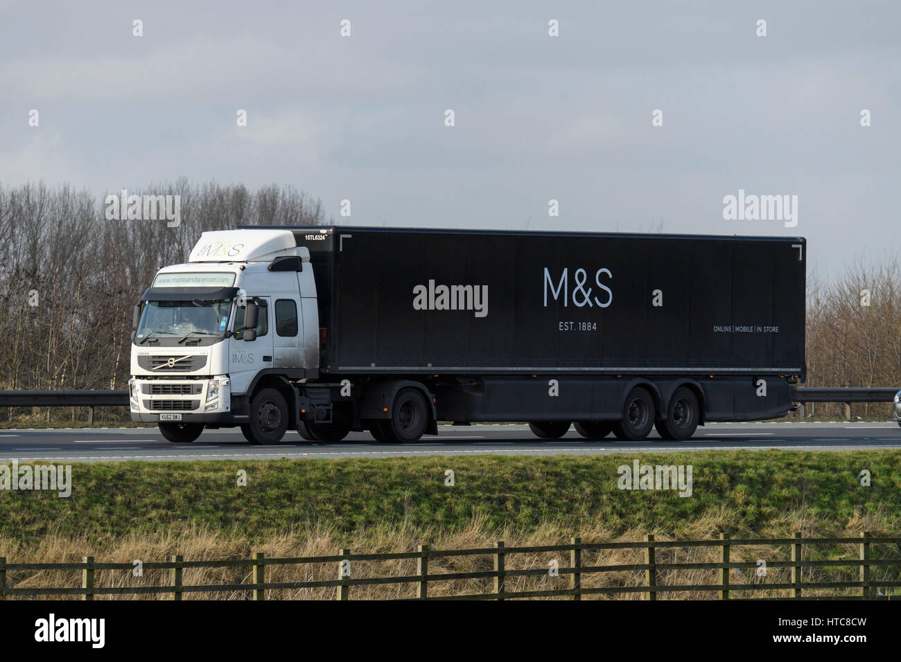Distribution & transportation - articulated lorry, heavy goods vehicle (HGV) with M & S logo travels on the A1 motorway - England, GB, UK. Stock Photo
