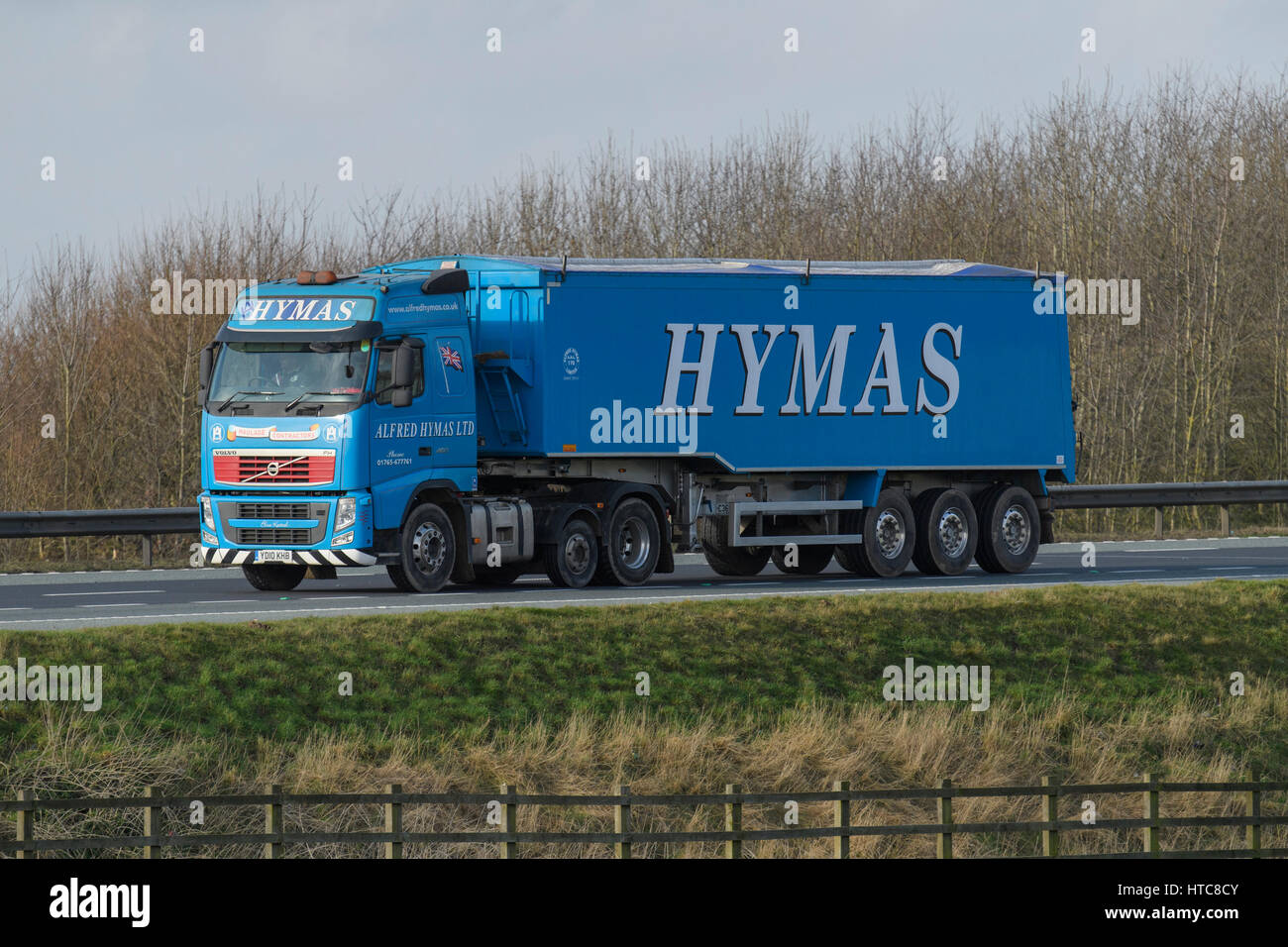 Distribution & transportation - articulated tipper lorry, heavy goods vehicle (HGV) with Hymas logo, travels on the A1 motorway - England, GB, UK. Stock Photo