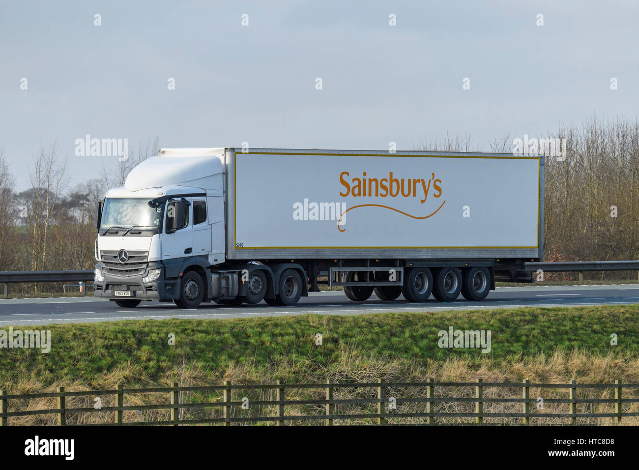 Distribution & transportation - an articulated lorry, heavy goods vehicle (HGV) with Sainsbury's logo travelling on the A1 motorway - England, GB, UK. Stock Photo