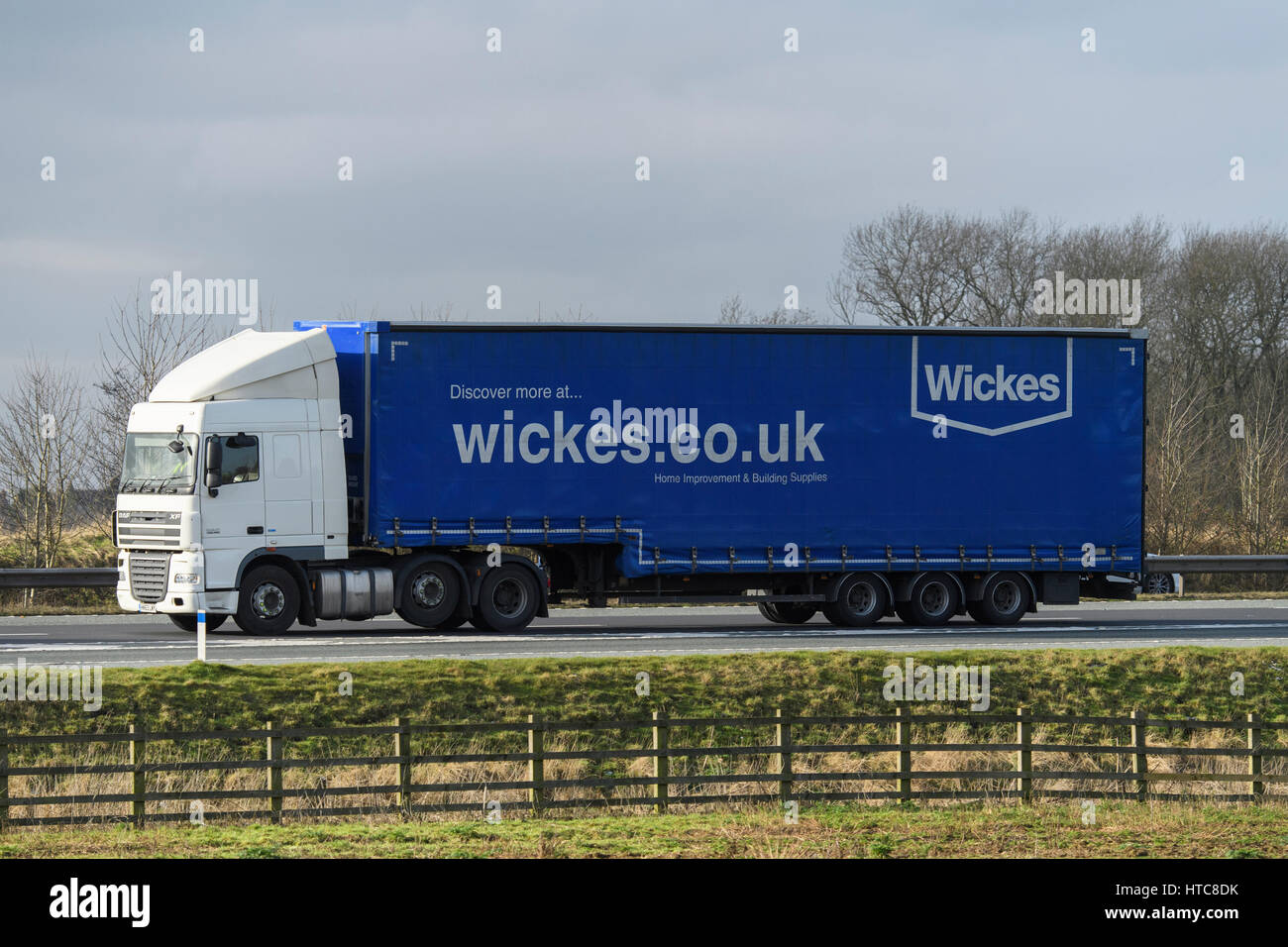 Distribution & transportation - an articulated lorry, heavy goods vehicle (HGV) with Wickes logo travelling on the A1 motorway - England, GB, UK. Stock Photo