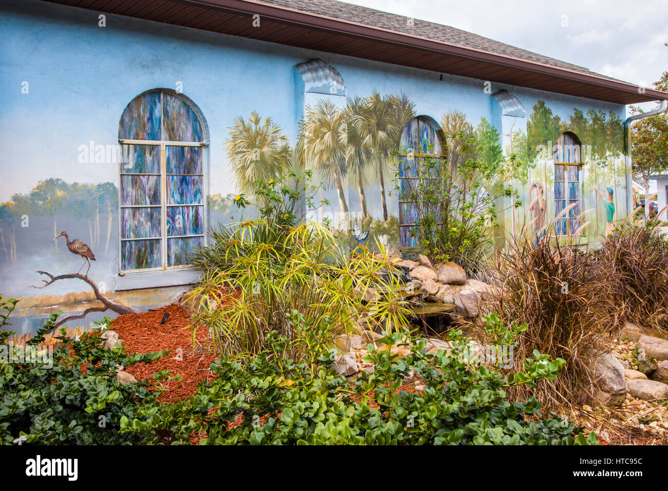 Art murals painted on outdoor building walls in Lake Placid Florida