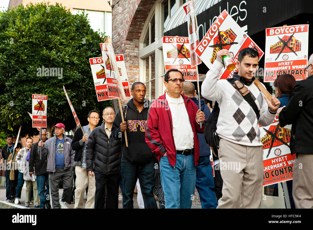 People marching holding boycott signs. Stock Photo