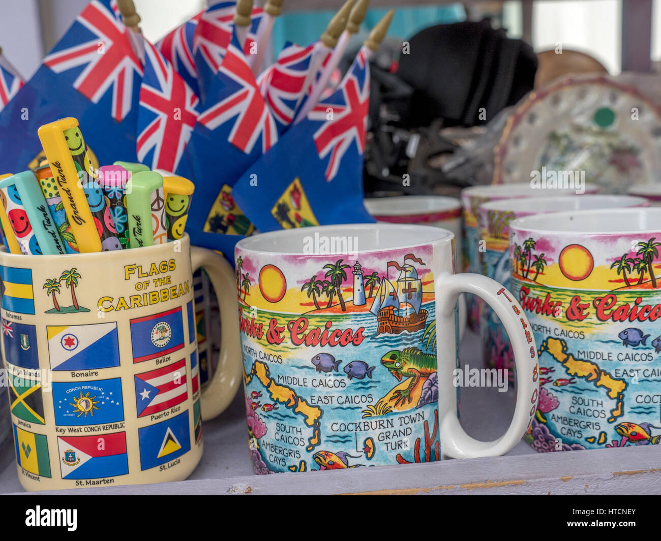 Turks And Caicos Tourist Souvenir Coffee Mugs, Pens And Flags For Sale At A Store On Grand Turk Stock Photo