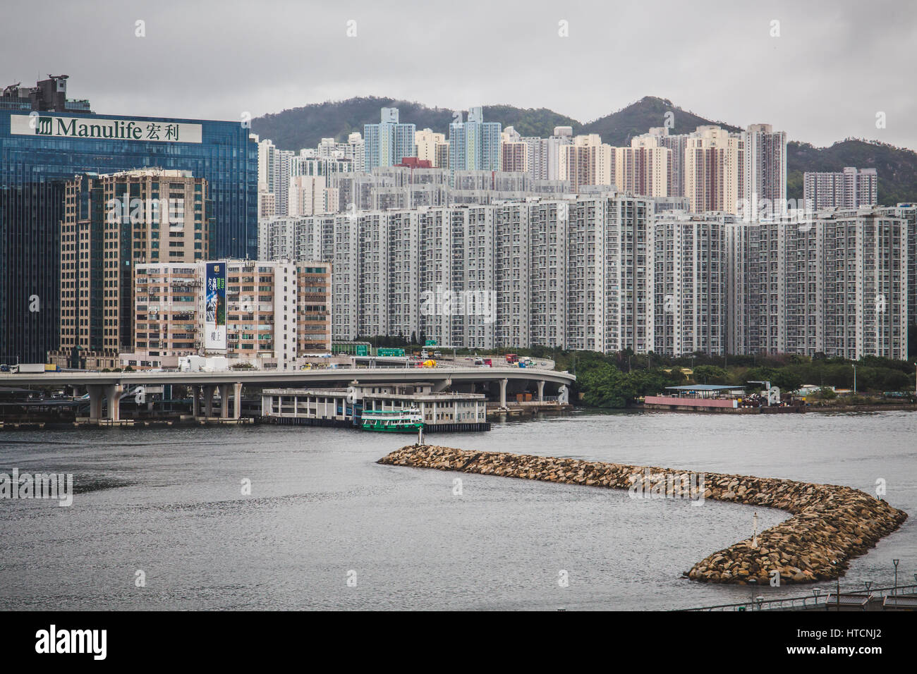 View of the Manulife Tower and Kwun Tong area across the Victoria Harbour  in Hong Kong, China Stock Photo - Alamy