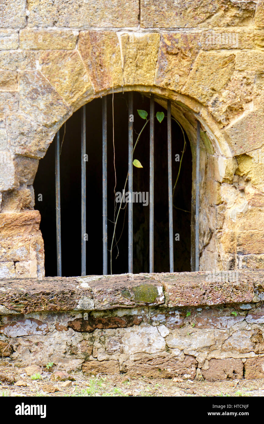 Bars on a window in one of the old prison buildings. This was a French penal colony in the early 1900's. Stock Photo