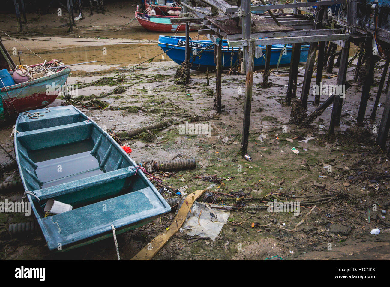 Rubbishes appear during low tide in Tai O fishing village, Hong Kong Stock Photo