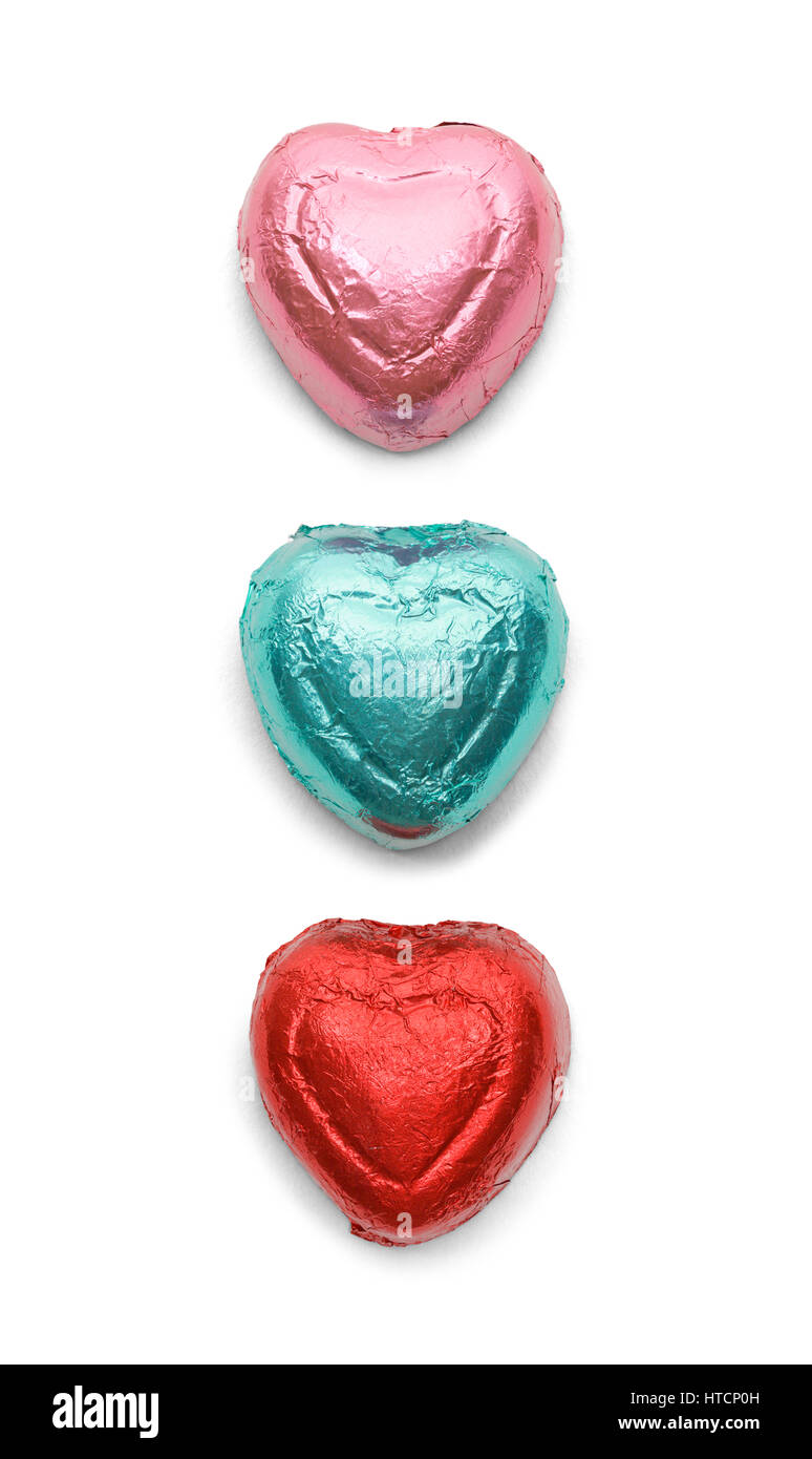 Three Chocolate Hearts in Foil Isolated on White Background. Stock Photo