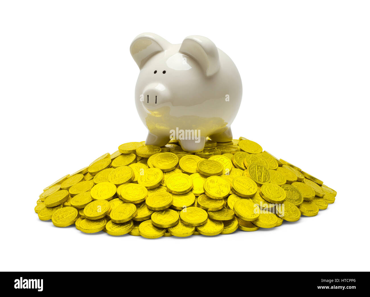 Piggy Bank on Top of Pile of Gold Coins Isolated on White. Stock Photo