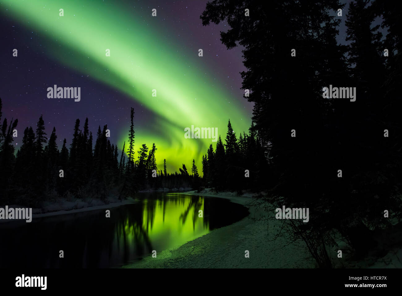 The aurora borealis reflects in the Clearwater River in Delta Junction