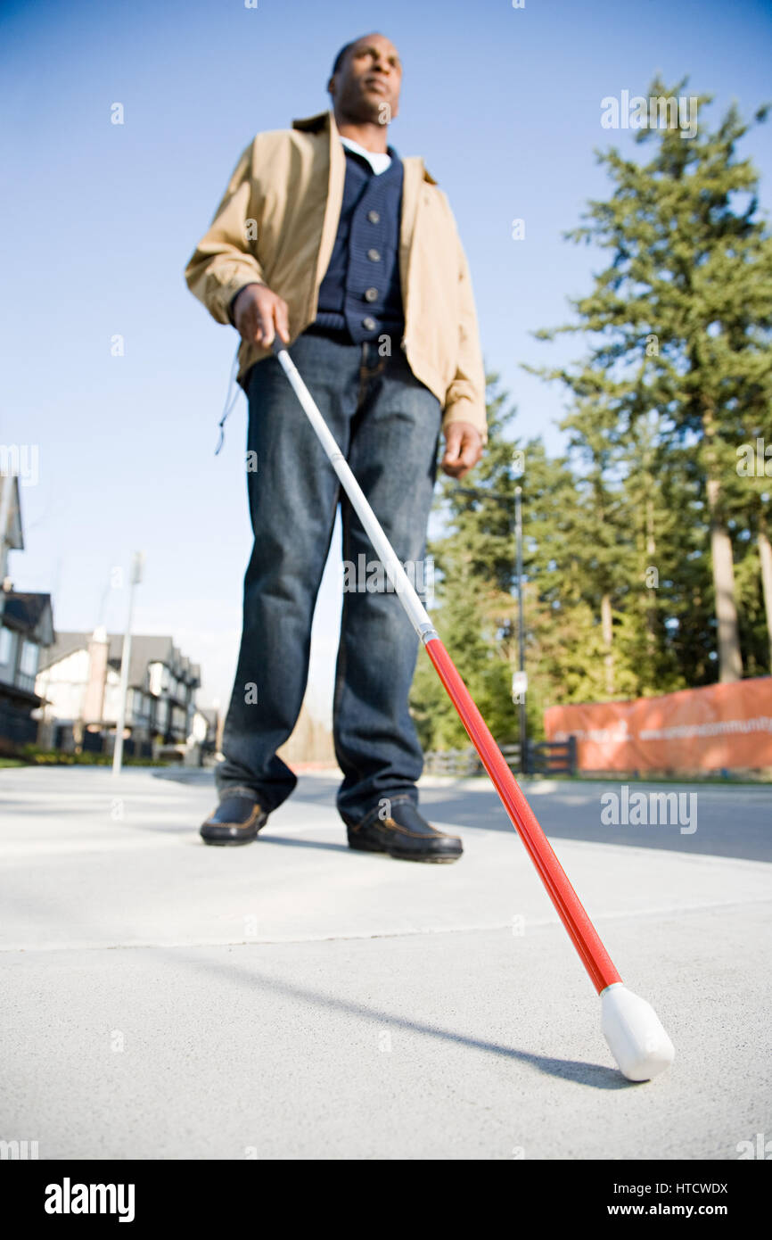 Blind man using a walking stick Stock Photo Alamy