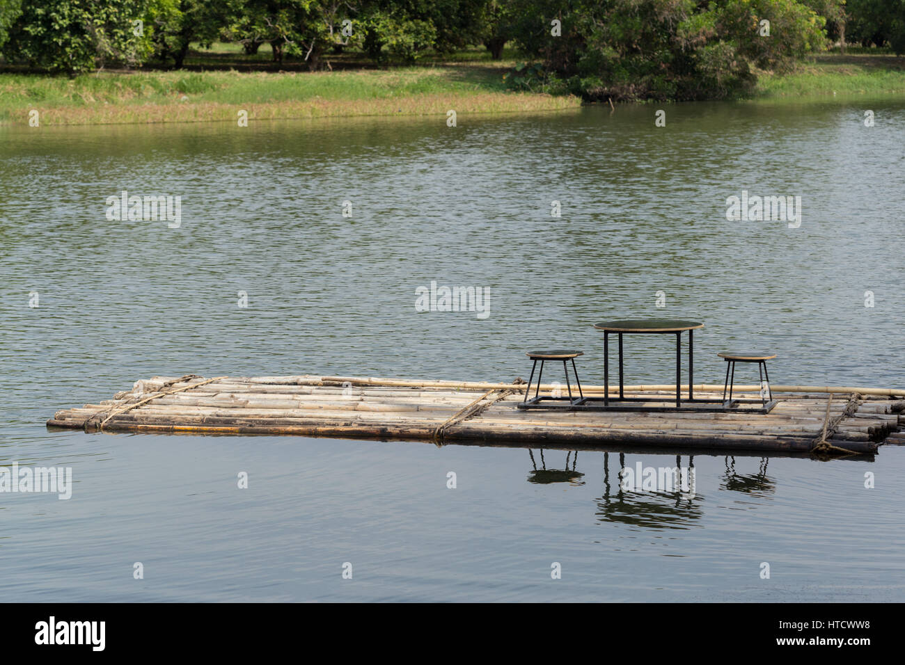 Bamboo rafts floating in the river and dining table and chair Stock Photo