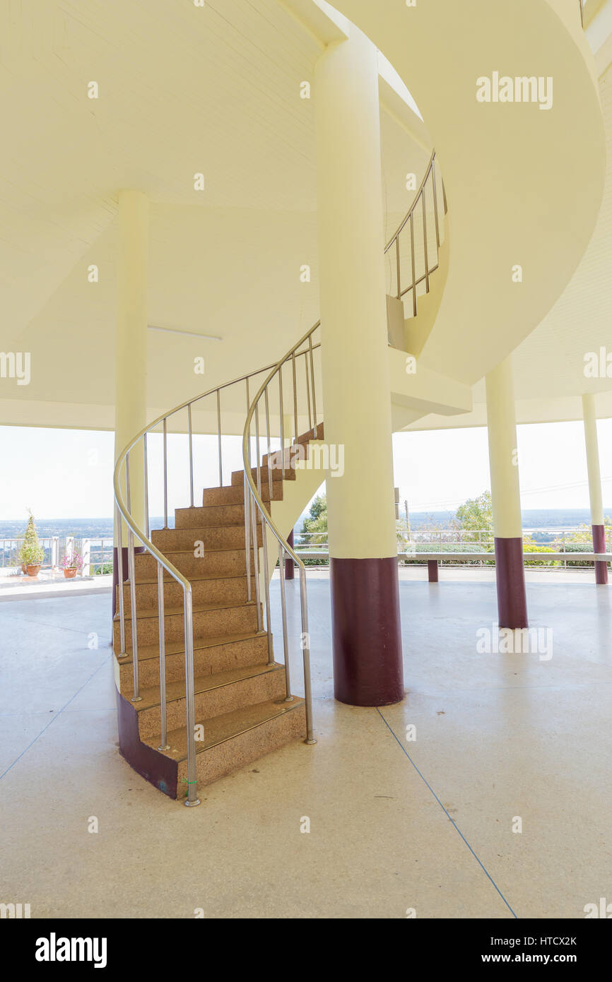 Beautiful spiral staircase with yellow wall Stock Photo