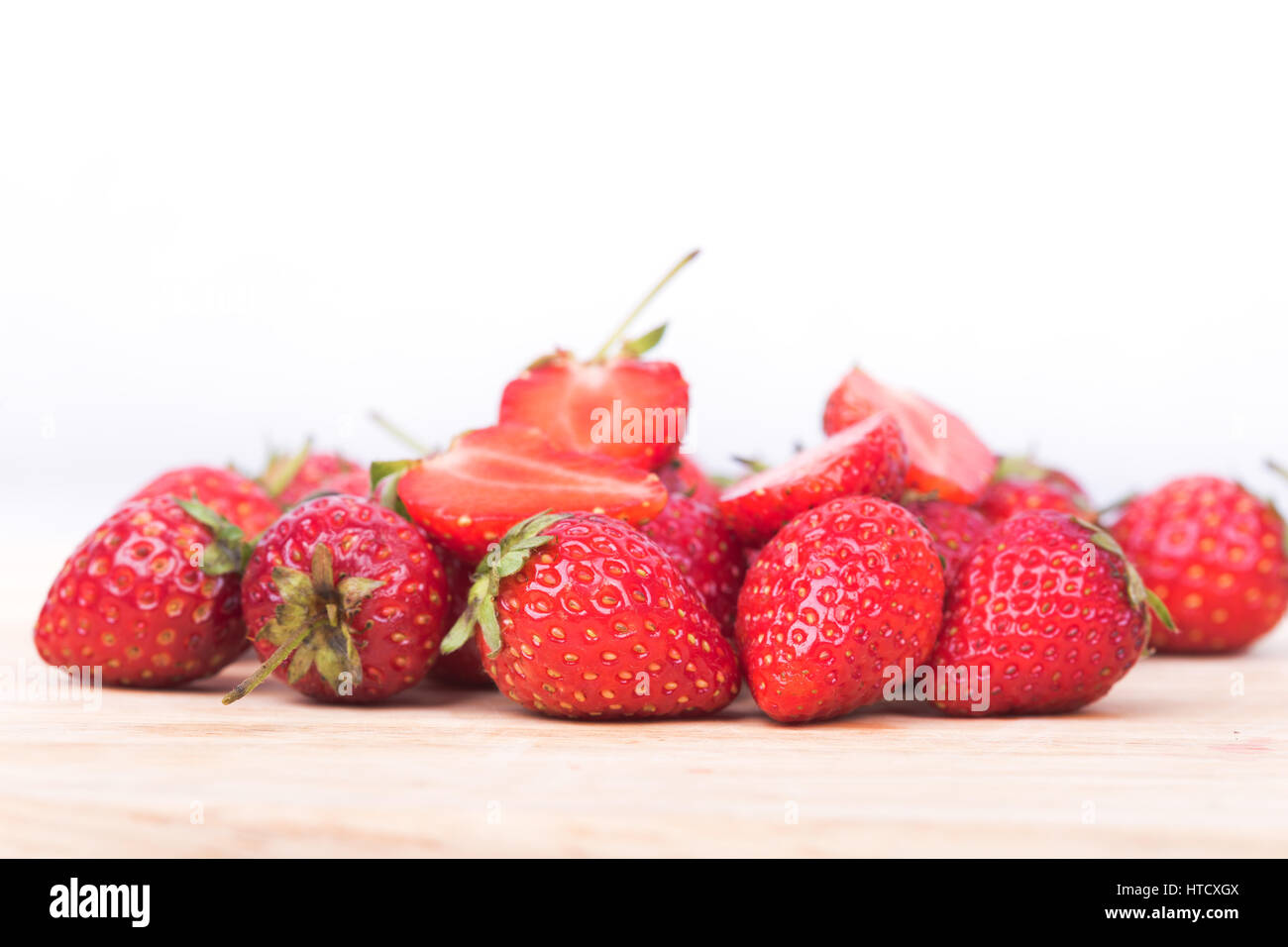 Fresh ripe strawberry on wood and white background Stock Photo - Alamy