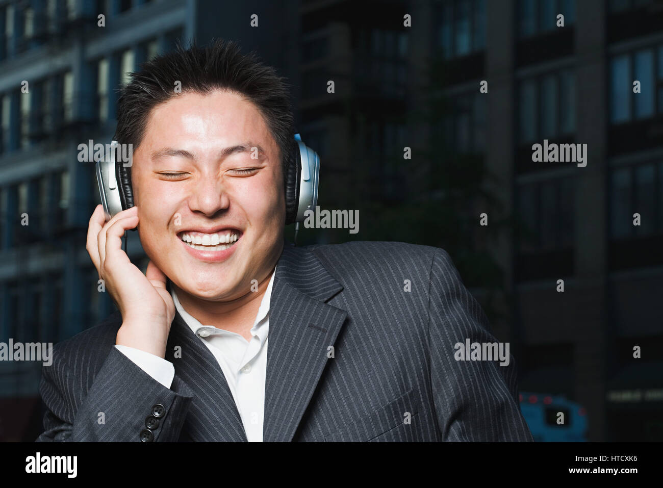 Man listening to headphones Stock Photo - Alamy
