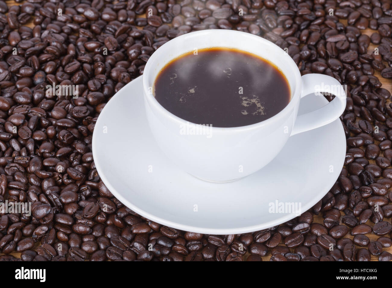 Coffee cup and beans on wooden table background Stock Photo - Alamy