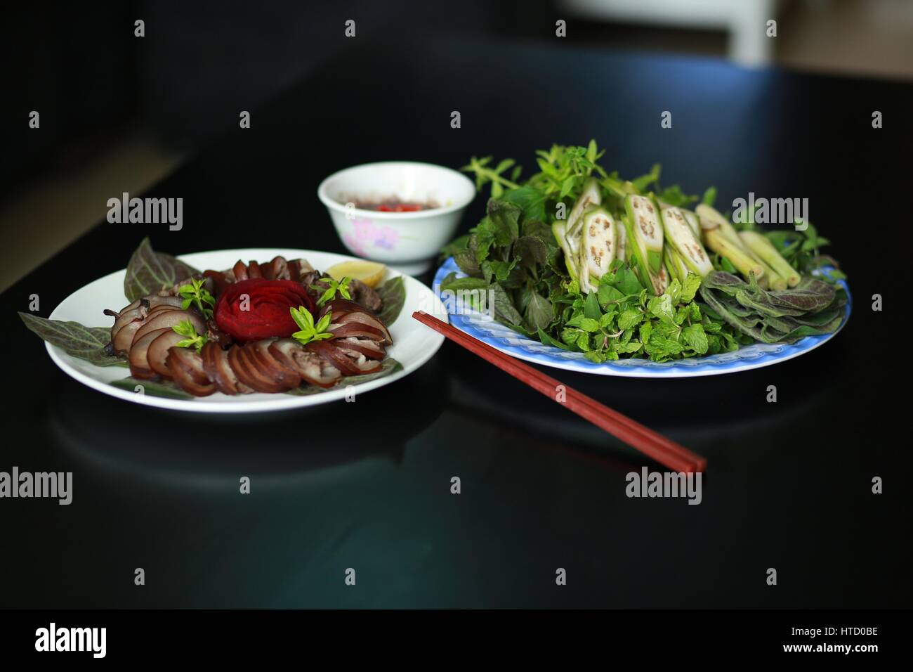 Steamed dog meat with herbs and sauces in Vietnam Stock Photo