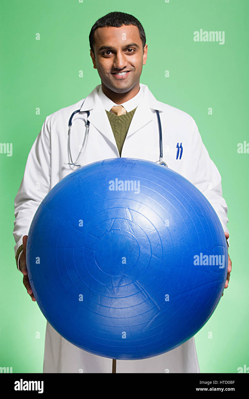 Doctor holding an exercise ball Stock Photo Alamy