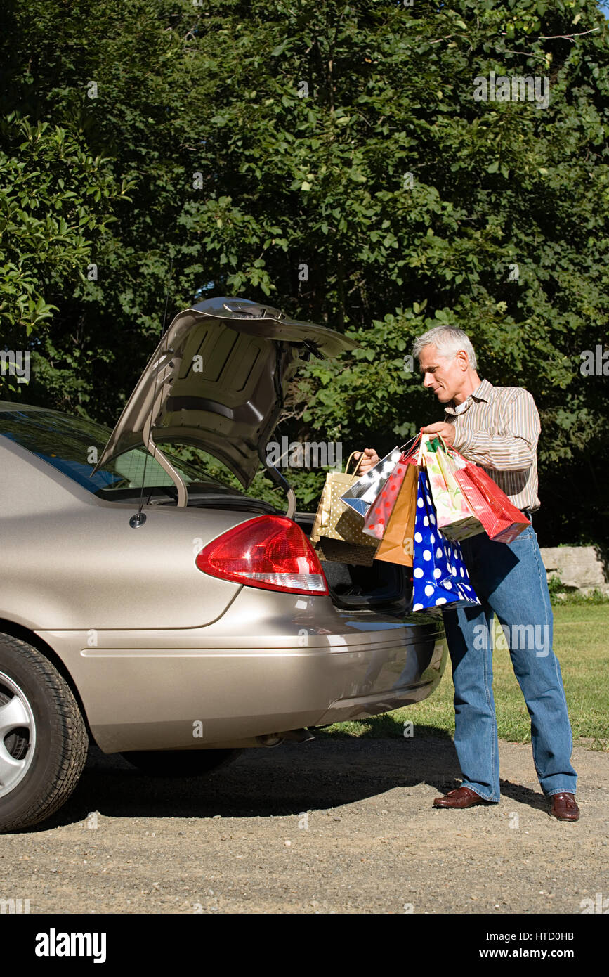 Man putting shopping bags in car Stock Photo Alamy