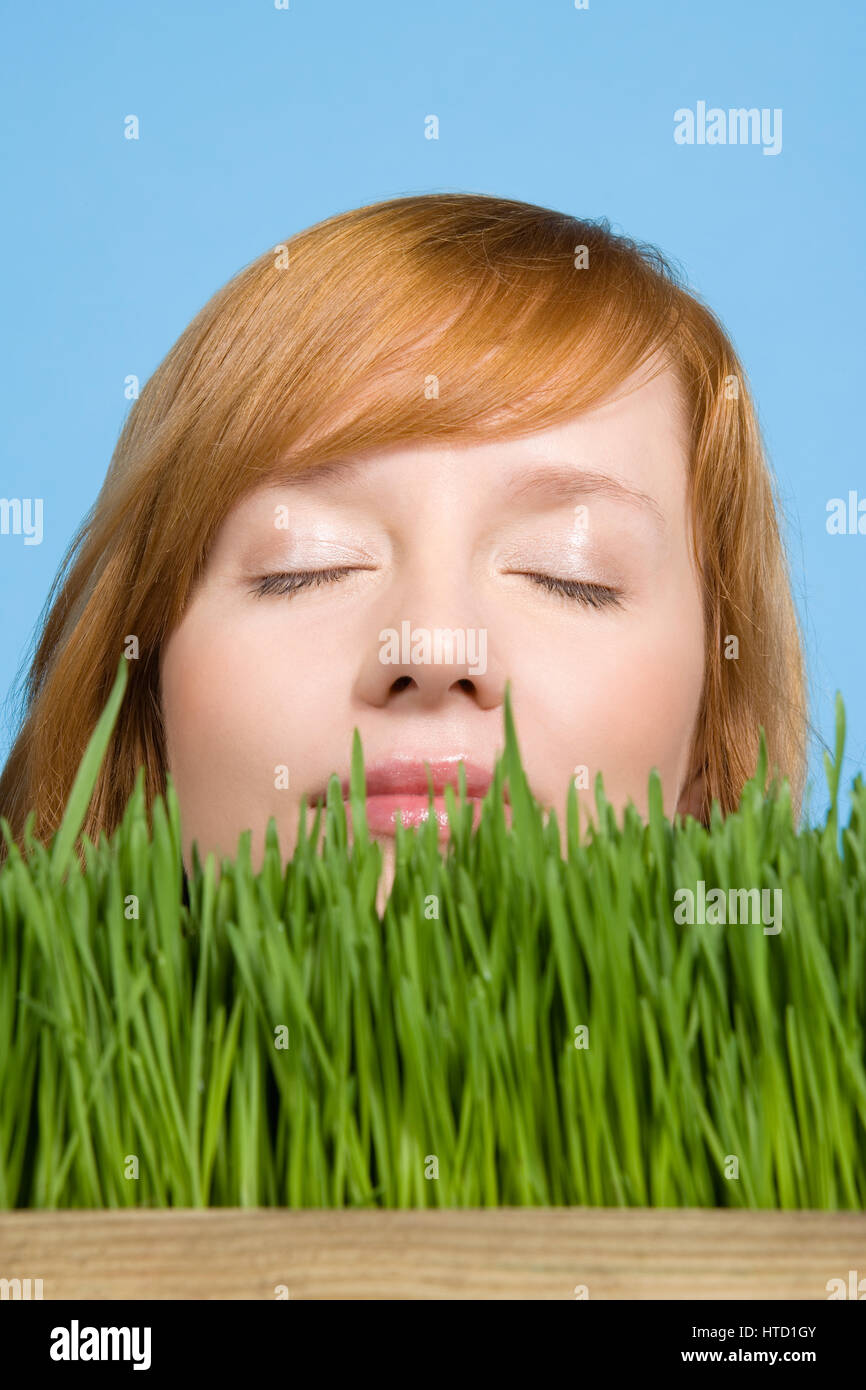 Woman smelling grass Stock Photo Alamy