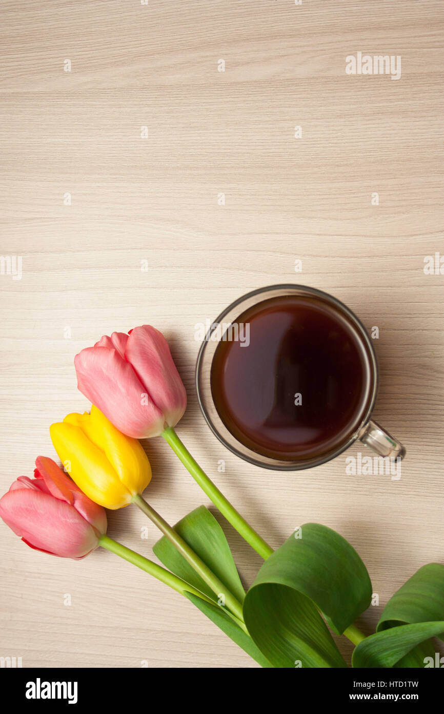black coffee and tulips on the table, top view, empty copyspace. Stock Photo