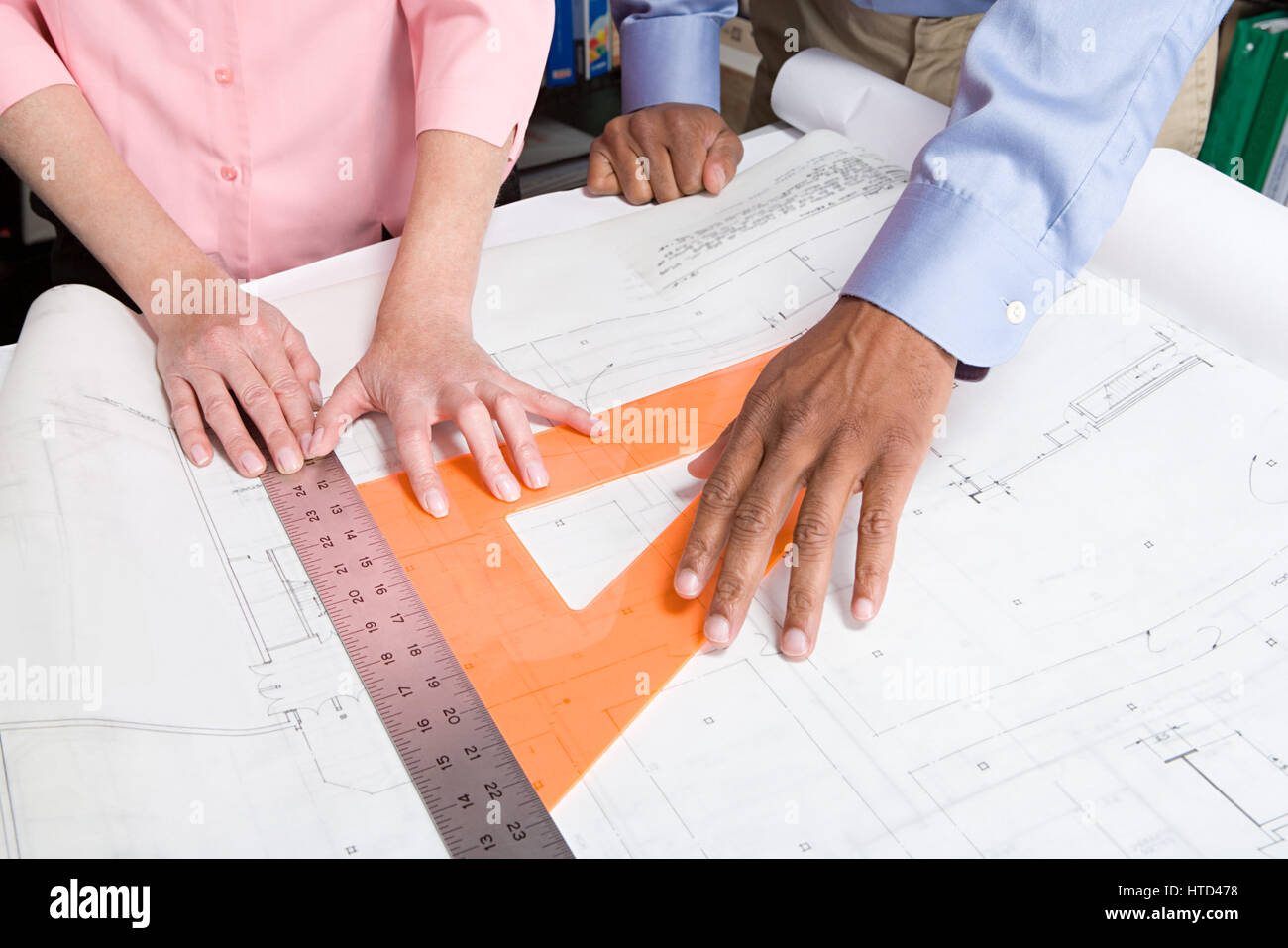 Architects measuring blueprint Stock Photo Alamy