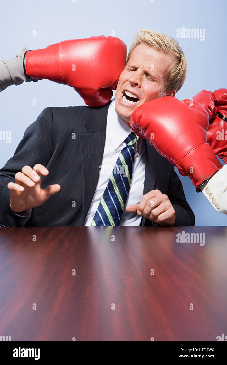 Businessman getting punched Stock Photo