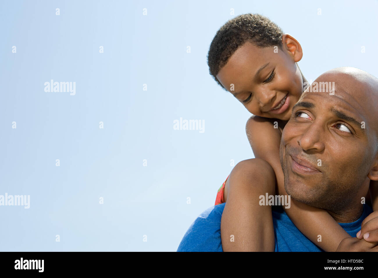 Son on fathers shoulders Stock Photo