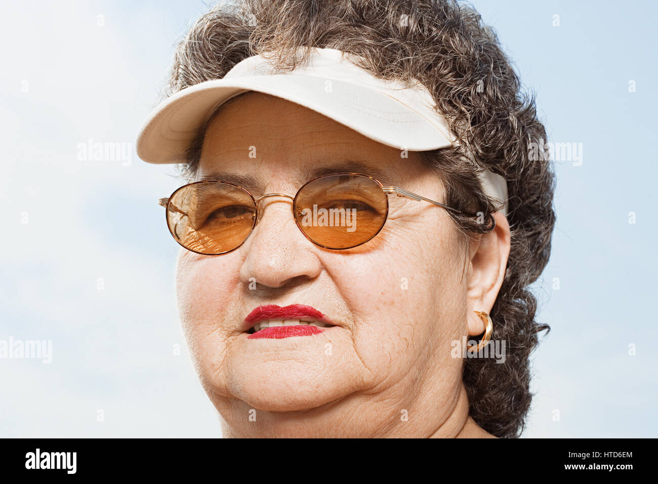 Woman wearing a sun visor Stock Photo Alamy
