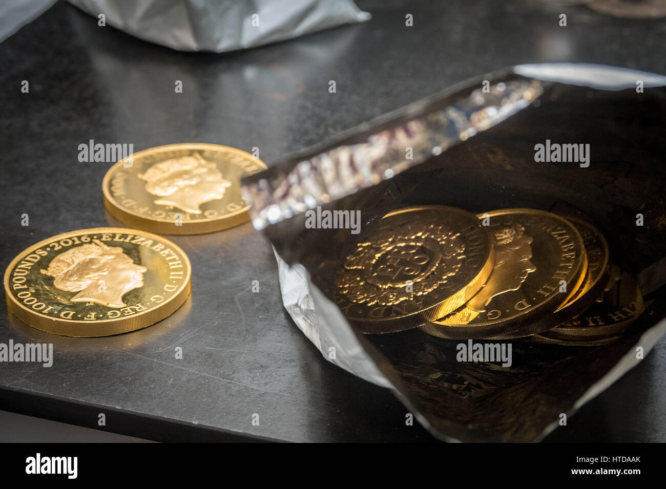 As well as standard 20p, 50p, £1, and £2 coins, the London Assay office also tests commemorative coins in their Laboratory at The Goldsmiths' Company Assay Office. Seen here a mix of gold proof sovereign coins. Stock Photo
