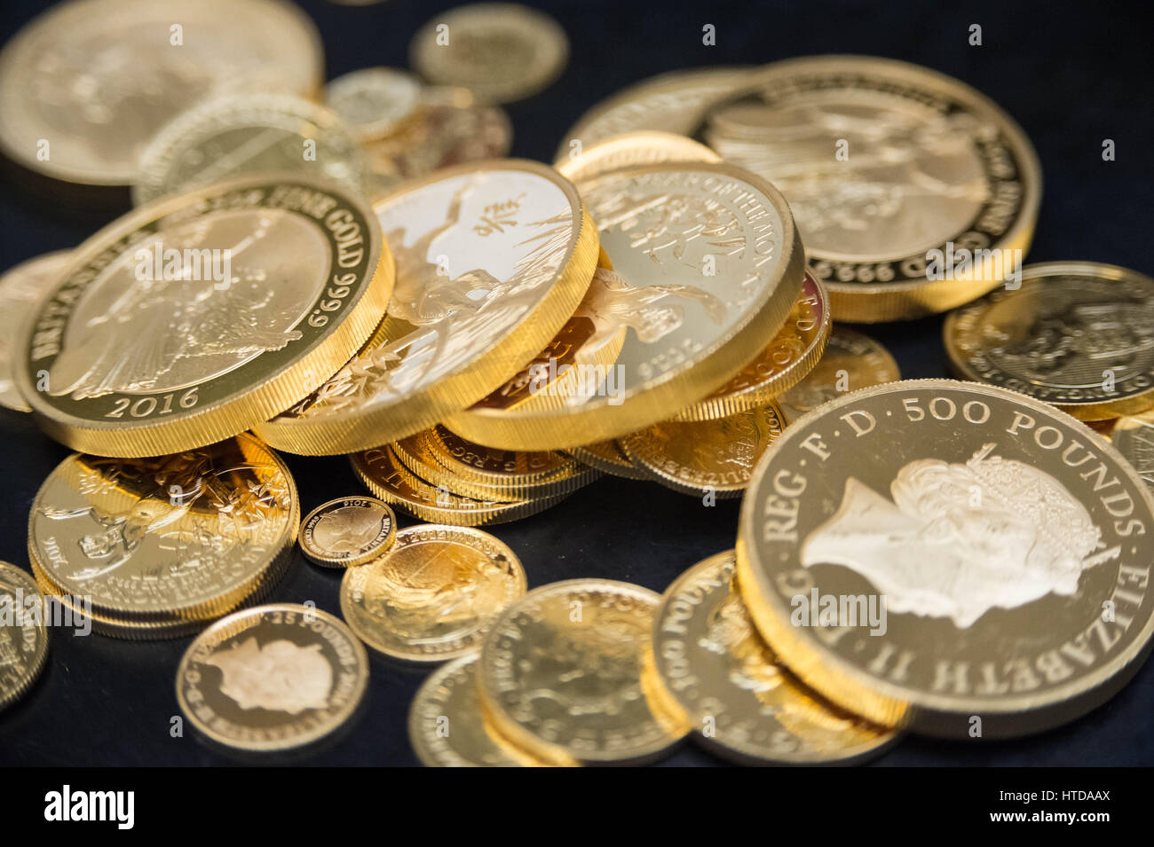 As well as standard 20p, 50p, £1, and £2 coins, the London Assay office also tests commemorative coins in their Laboratory at The Goldsmiths' Company Assay Office. Seen here a mix of gold proof sovereign coins. Stock Photo