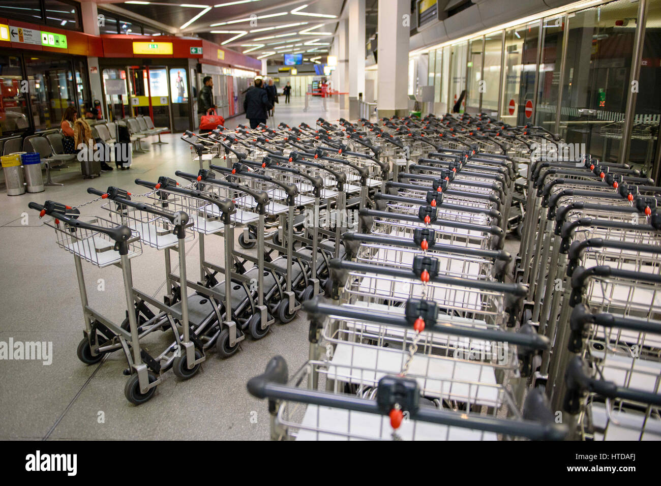 Berlin, Germany. 10th Mar, 2017. Unused baggage carts seen in a terminal building at Tegel Airport in Berlin, Germany, 10 March 2017. German trade union Verdi had called on some 2,000 ground staff to join the strike. The strike began on 10 March 2017 at 03:00 GMT and is to end on 11 March 2017 at 04:00 GMT. The main reason for the strike is the ongoing labour dispute between Verdi and the Forum of Ground Transport Service Providers in which the companies operating at the airports are organized. The trade union is demanding a pay rise for ground staff. Photo: Gregor Fischer/dpa/Alamy Live News Stock Photo