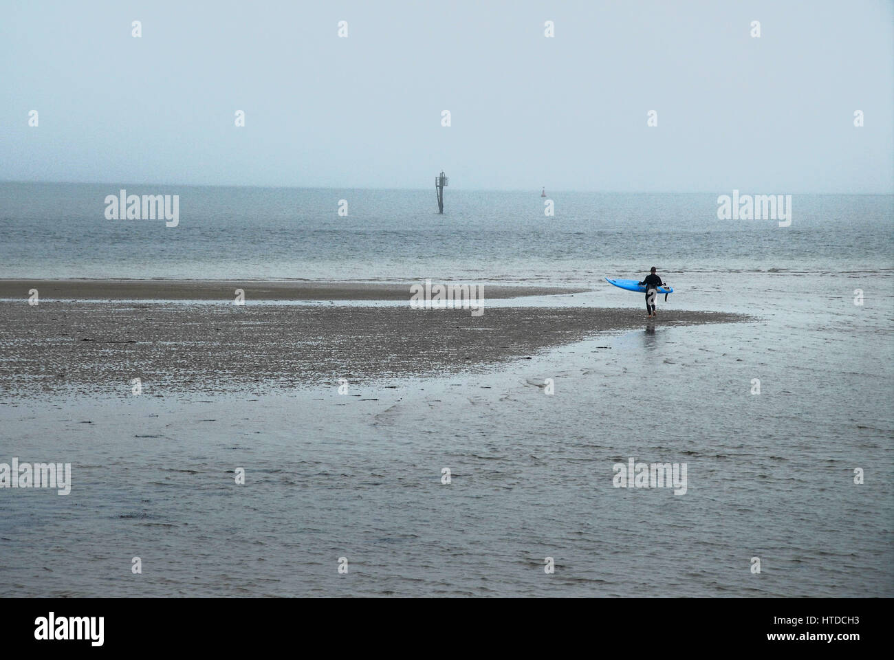 Weymouth & Portland, Dorset, 2017, Rising temperatures brings sea mist, as people enjoy the beach and the harbour on an overcast day Stock Photo