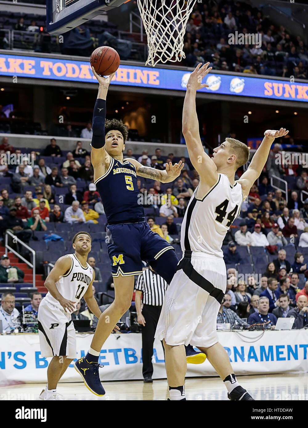 Washington, DC, USA. 10th Mar, 2017. Michigan Wolverines F #5 D.J. Wilson takes a shot under the basket in front of Purdue Boilermakers C #44 Isaac Hass during a Big 10 Men's Basketball Tournament game between the Purdue Boilermakers and the Michigan Wolverines at the Verizon Center in Washington, DC. Justin Cooper/CSM/Alamy Live News Stock Photo