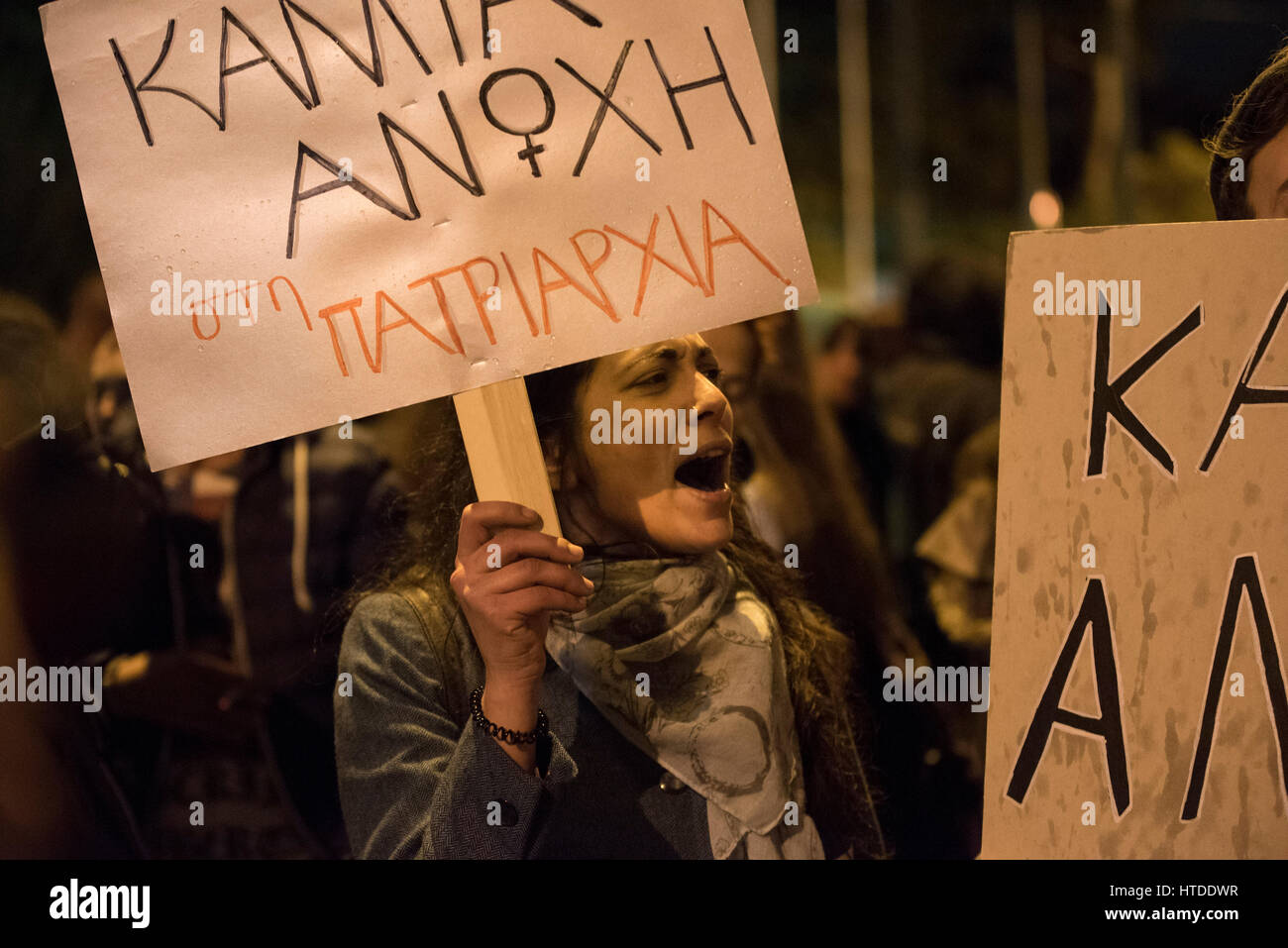 Women and men march in the streets of Athens shouting slogans and holding placards. Feminist, leftist and human rights organizations staged a demonstration to honor International Women's Day and demand equal rights. © Nikolas Georgiou / Alamy Live News Stock Photo
