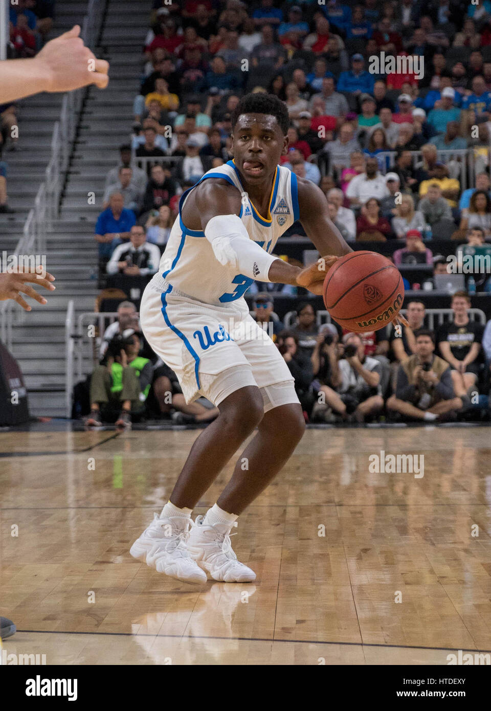 Las Vegas, NV, USA. 09th Mar, 2017. UCLA guard (3) Aaron Holiday makes a pass during the game between the USC Trojans vs the UCLA Bruins in the Pac-12 tournament at T-Mobile Arena in Las Vegas, Nevada. UCLA defeated USC 76-74.(Mandatory Credit: Juan Lainez/MarinMedia/Cal Sport Media) Credit: csm/Alamy Live News Stock Photo