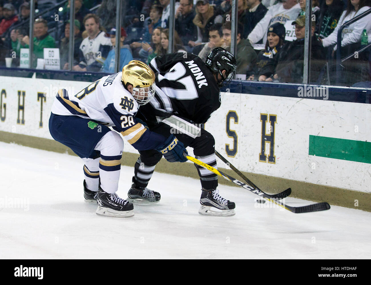South Bend, Indiana, USA. 10th Mar, 2017. Notre Dame forward Jack Jenkins (28) and Providence defenseman Josh Monk (27) battle for the puck during NCAA Hockey game action between the Notre Dame Fighting Irish and the Providence College Friars at Compton Family Ice Arena in South Bend, Indiana. John Mersits/CSM/Alamy Live News Stock Photo