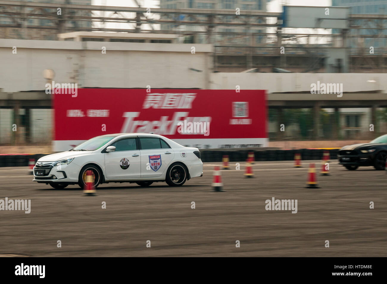 Shanghai, China. 11th March 2017. Drag racing event at Shanghai's old Expo site organised by fast4ward and iWagon. A BYD Qin out runs a Mustang in the drag race. Credit: Mark Andrews/Alamy Live News Stock Photo