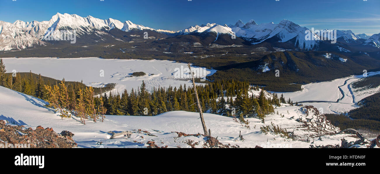Panoramic Aerial WInter Landscape View Distant Snowy Mountains and Frozen Spray Lakes in Kananaskis Country Rocky Mountains Alberta Canada Stock Photo