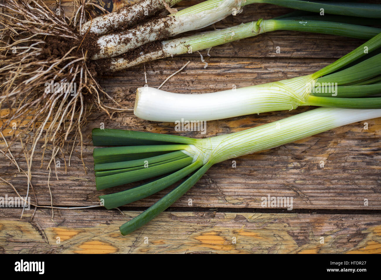 Fresh raw spring onions on a wooden board Stock Photo - Alamy