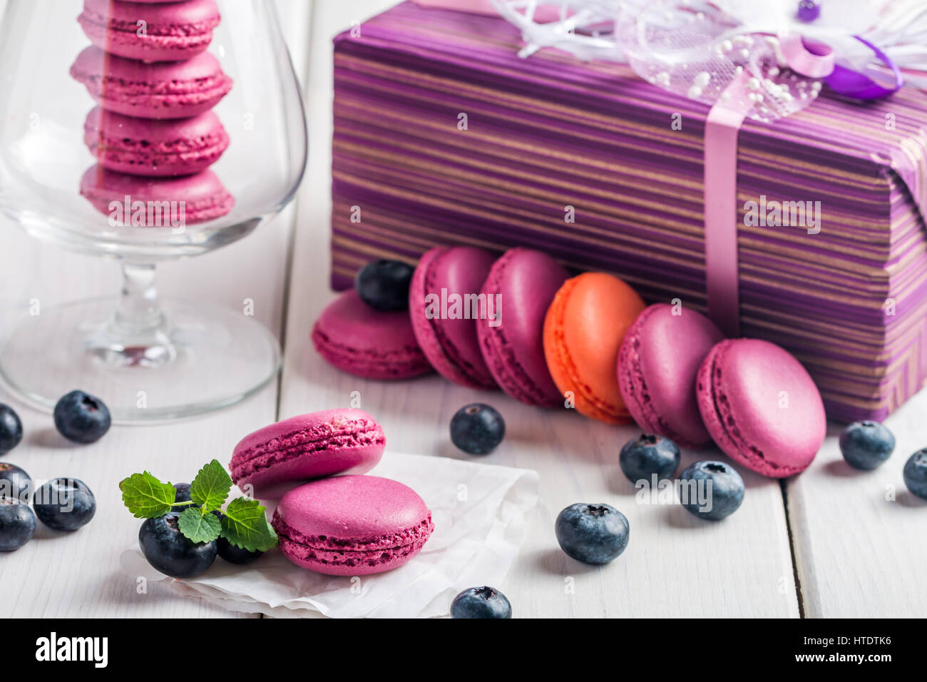 Violet macaroon with fresh  blueberries on white wooden background Stock Photo