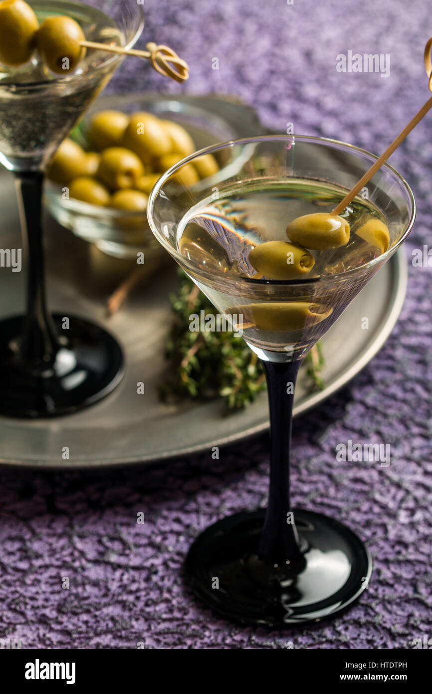 Two glasses of Dry Martini, classic cocktail with olives, vodka and gin